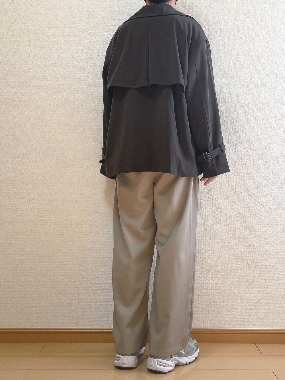 ブラウン系のトレンチコート、ブラウン系のニット/セーター、グレー系のその他パンツを着用したメンズの冬コーディネートの4枚目の写真