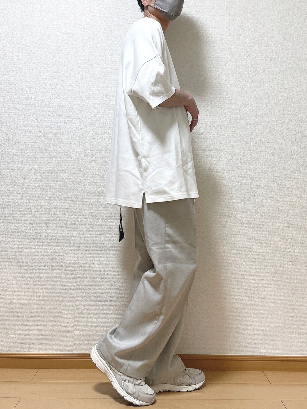 ホワイト系のTシャツ/カットソー、ベージュ系のその他パンツ、ホワイト系のスニーカーを着用したメンズの春コーディネートの2枚目の写真