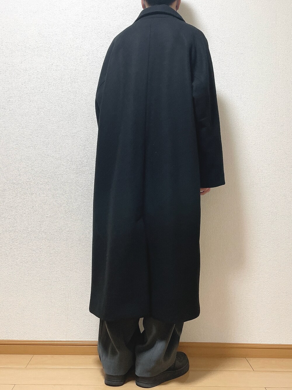 ブラック系のステンカラーコート、ブラウン系のシャツ/ブラウス、ブラック系のTシャツ/カットソーを着用したメンズの冬コーディネートの4枚目の写真