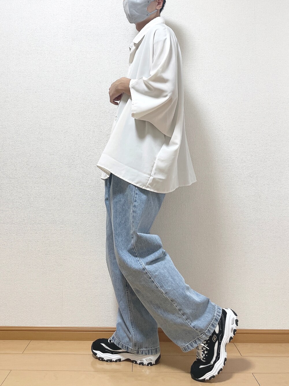 ホワイト系のシャツ/ブラウス、ブルー系のデニムパンツ、ブラック系のスニーカーを着用したメンズの秋コーディネートの3枚目の写真