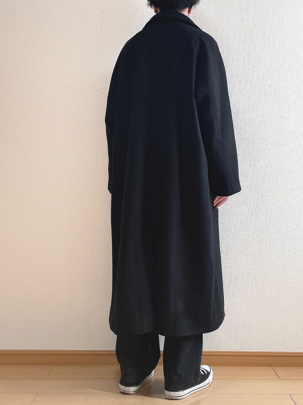 ブラック系のステンカラーコート、ブラウン系のスウェット、ホワイト系のTシャツ/カットソーを着用したメンズの冬コーディネートの4枚目の写真
