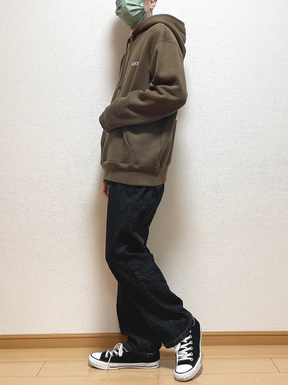 ブラウン系のパーカー、ホワイト系のTシャツ/カットソー、ブラック系のデニムパンツを着用したメンズの冬コーディネートの2枚目の写真