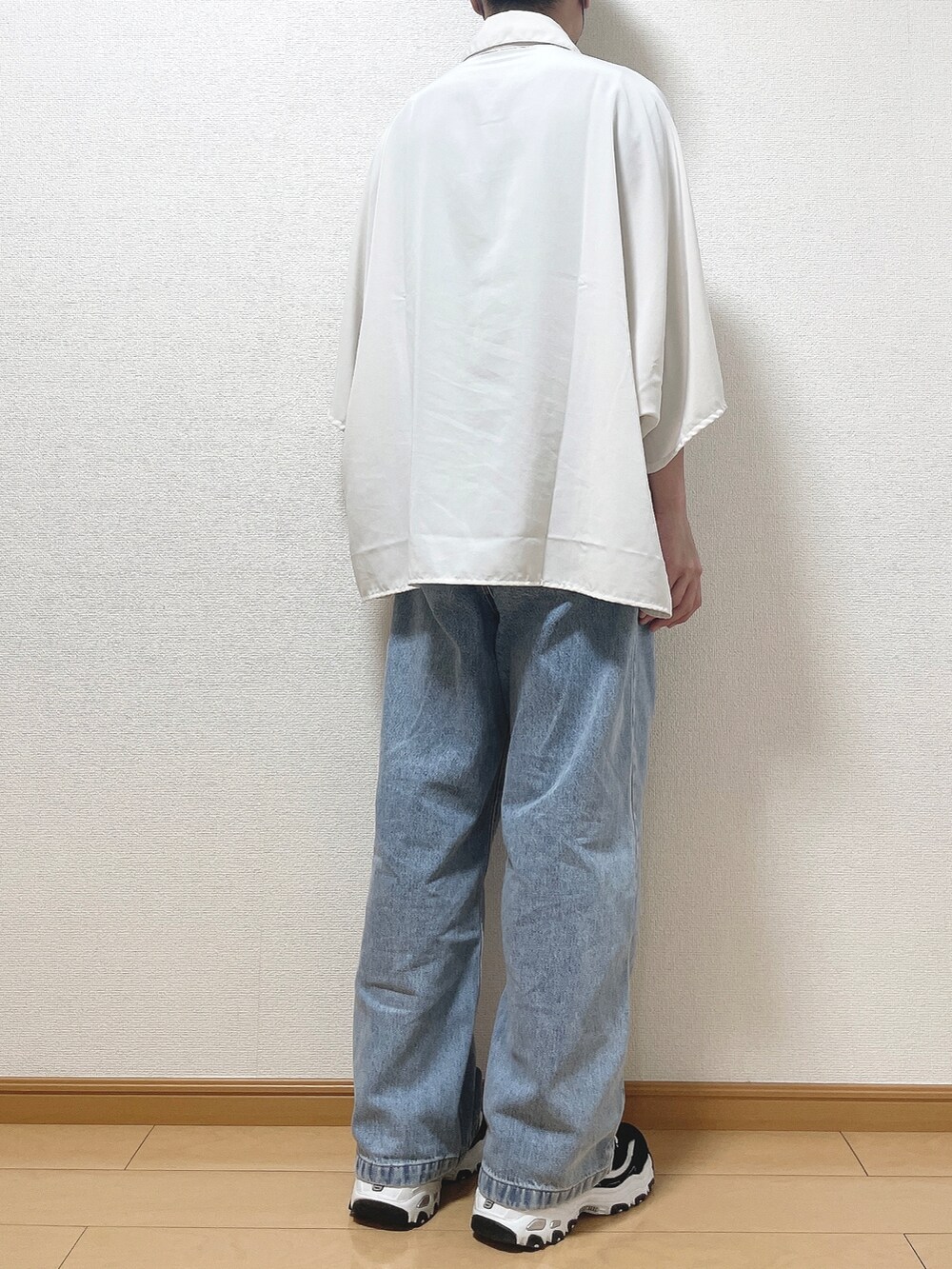 ホワイト系のシャツ/ブラウス、ブルー系のデニムパンツ、ブラック系のスニーカーを着用したメンズの秋コーディネートの4枚目の写真