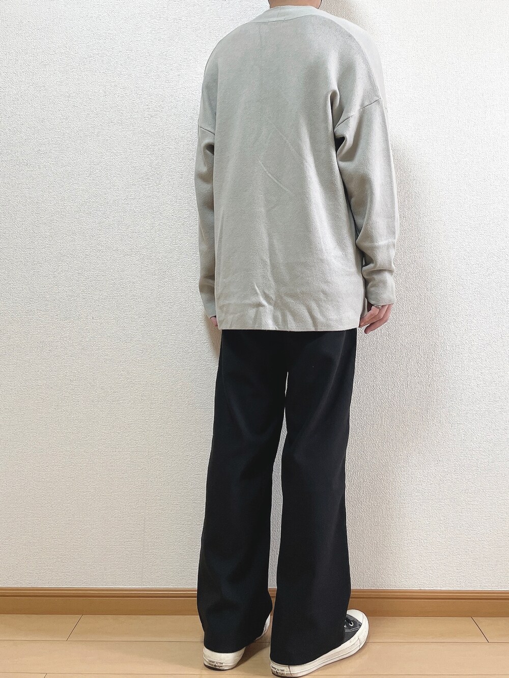グレー系のカーディガン/ボレロ、ホワイト系のTシャツ/カットソー、ブラック系のスラックスを着用したメンズの秋コーディネートの4枚目の写真