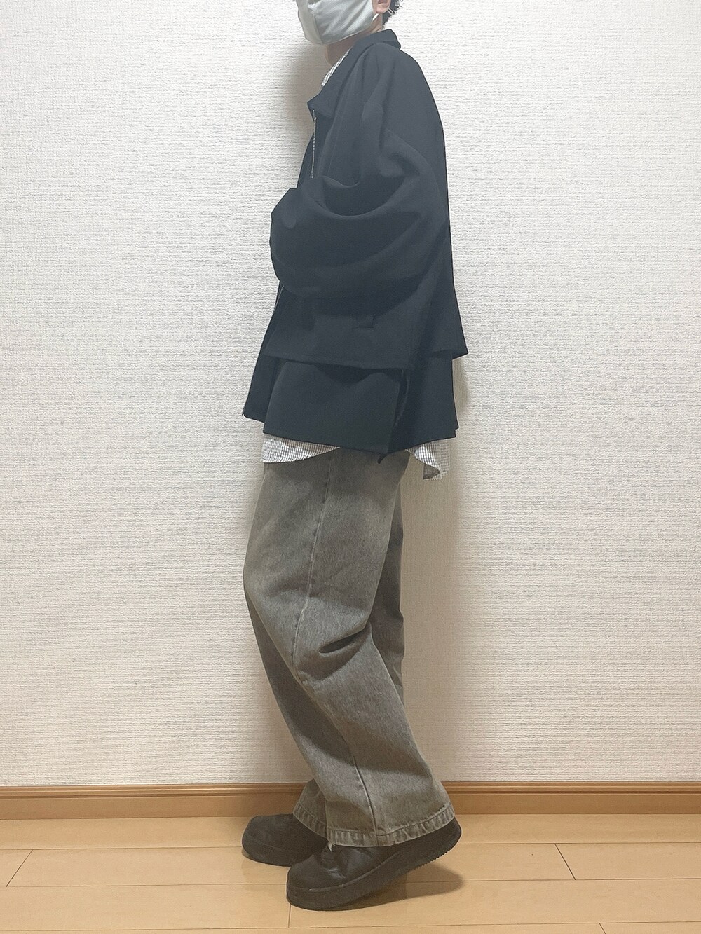 ブラック系のブルゾン、ブルー系のシャツ/ブラウス、ブラック系のデニムパンツを着用したメンズの秋コーディネートの3枚目の写真