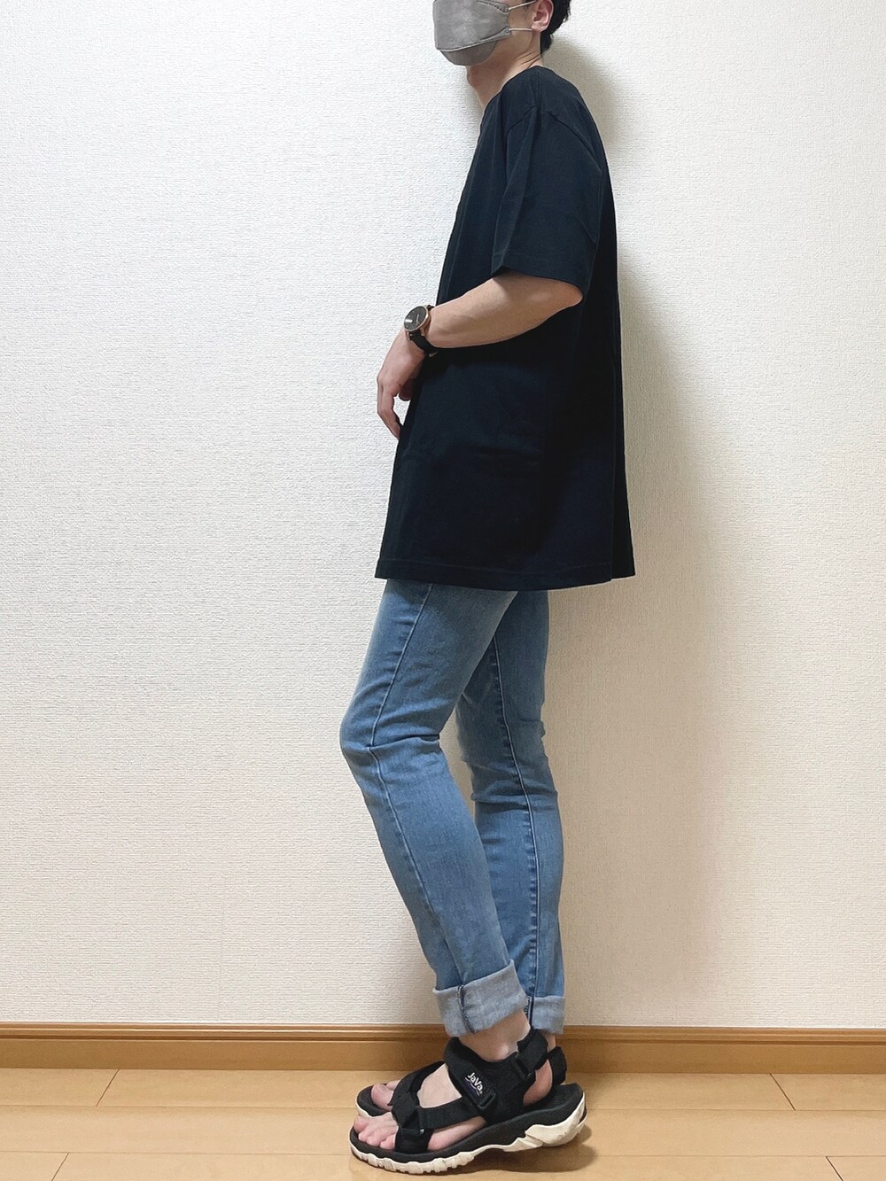 ブラック系のTシャツ/カットソー、ブルー系のデニムパンツ、ブラック系のサンダルを着用したメンズの夏コーディネートの3枚目の写真