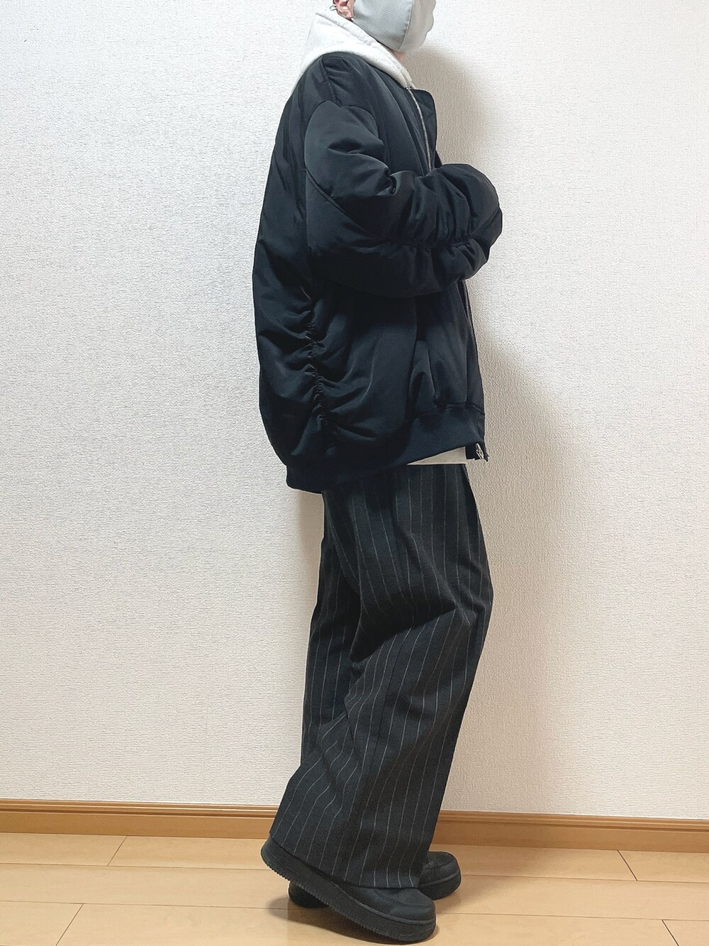ブラック系のMA-1、グレー系のパーカー、ブラック系のTシャツ/カットソーを着用したメンズの冬コーディネートの2枚目の写真