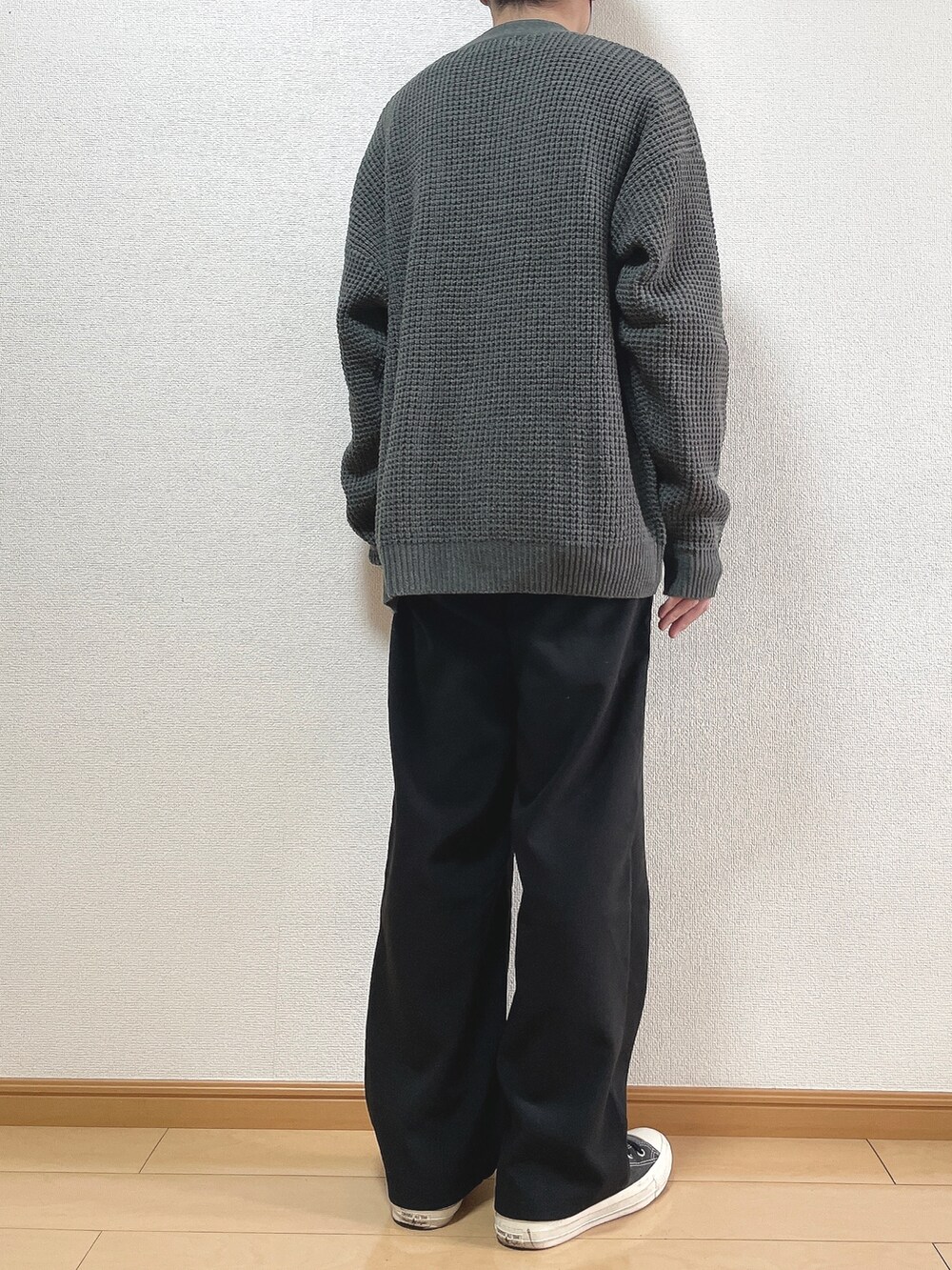 グレー系のカーディガン/ボレロ、ホワイト系のTシャツ/カットソー、ブラック系のスラックスを着用したメンズの秋コーディネートの4枚目の写真