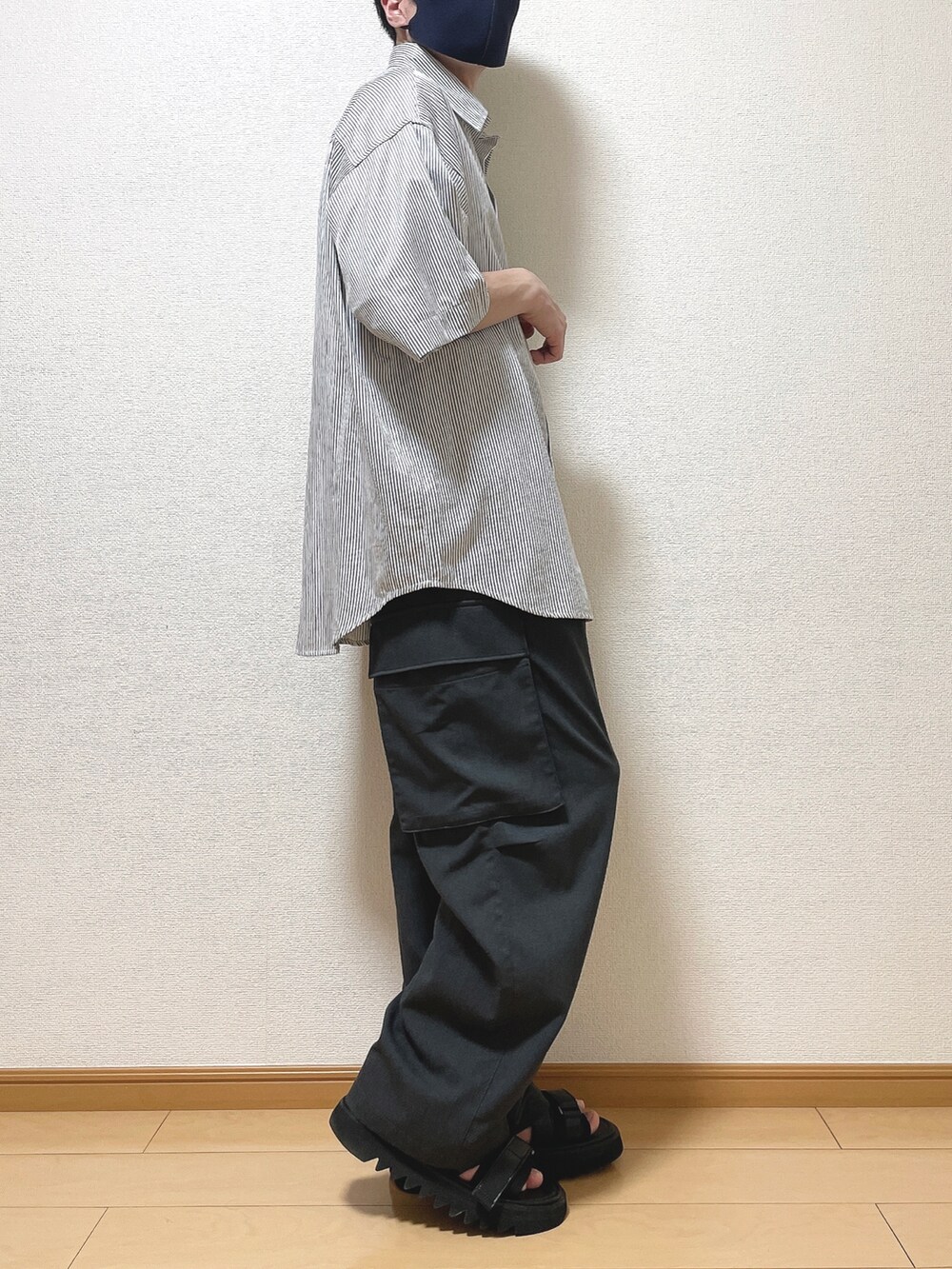 ブルー系のシャツ/ブラウス、グレー系のカーゴパンツ、ブラック系のサンダルを着用したメンズの夏コーディネートの2枚目の写真