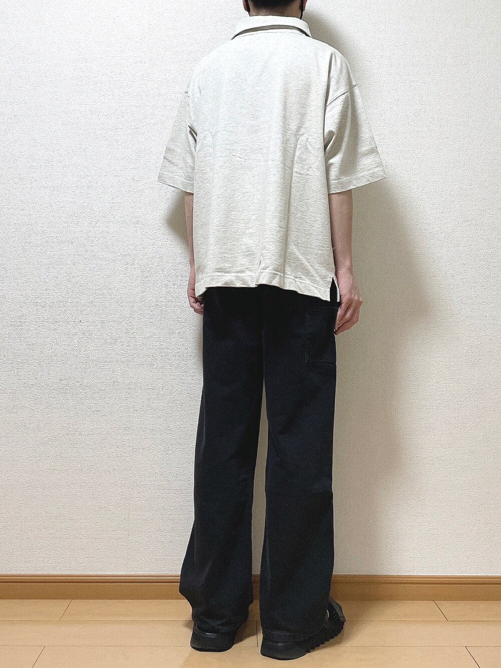 ベージュ系のTシャツ/カットソー、ブラック系のデニムパンツ、ブラック系のサンダルを着用したメンズの春コーディネートの4枚目の写真