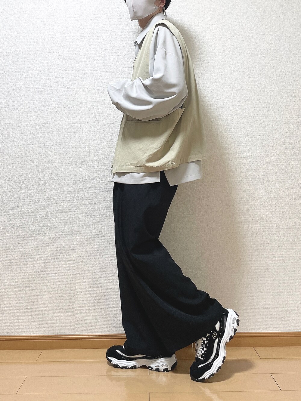 ベージュ系のベスト、グレー系のシャツ/ブラウス、ブラック系のスラックスを着用したメンズの春コーディネートの3枚目の写真