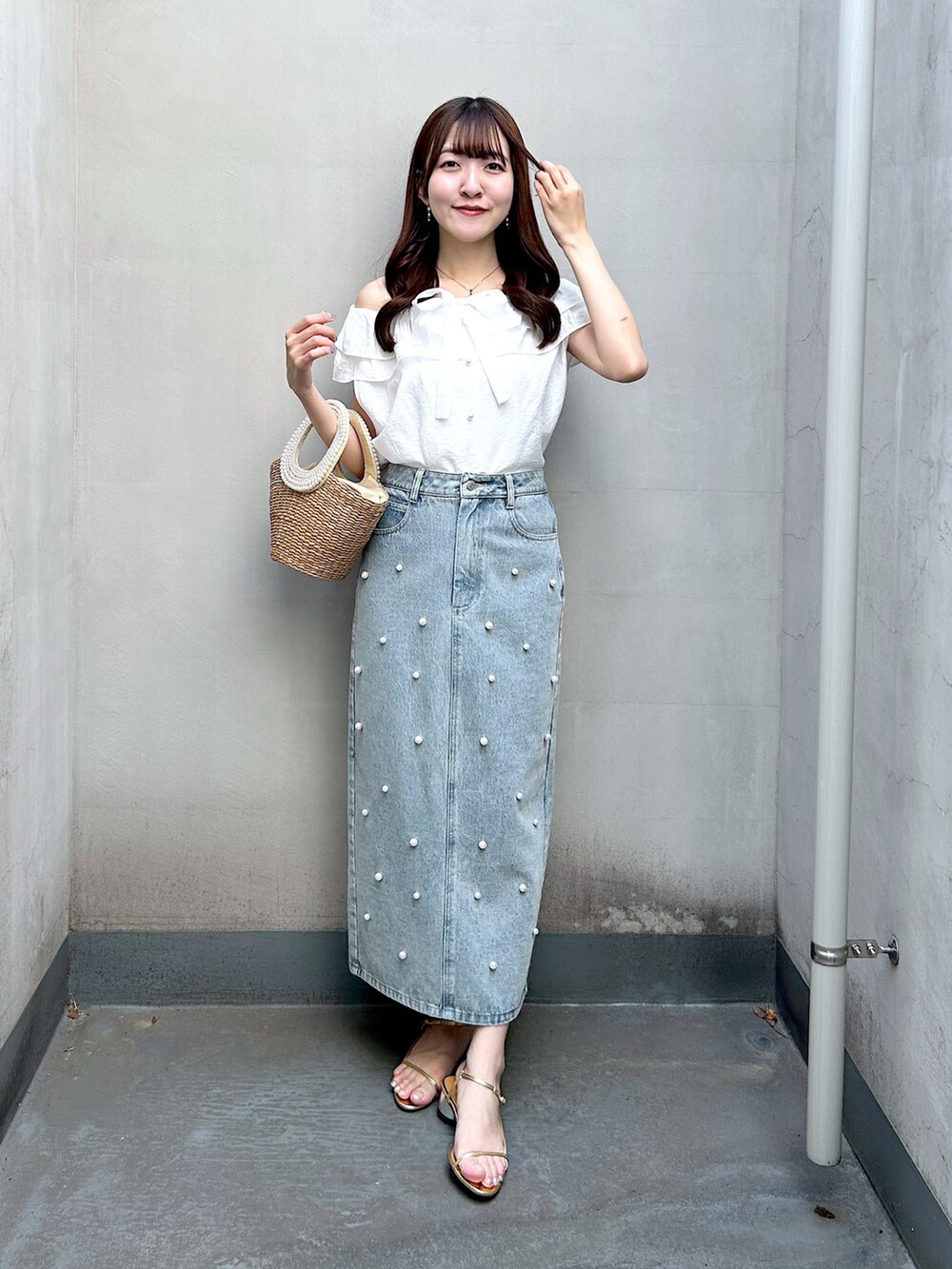 ホワイト系のシャツ/ブラウス、ブルー系のスカート、ベージュ系のかごバッグを着用したレディースの春コーディネートの2枚目の写真