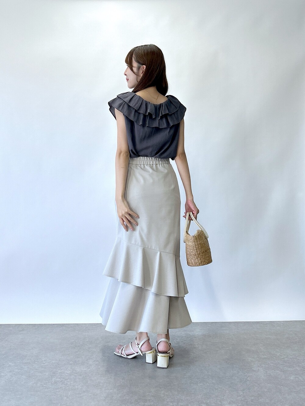 グレー系のシャツ/ブラウス、ベージュ系のスカートを着用したレディースの夏コーディネートの3枚目の写真