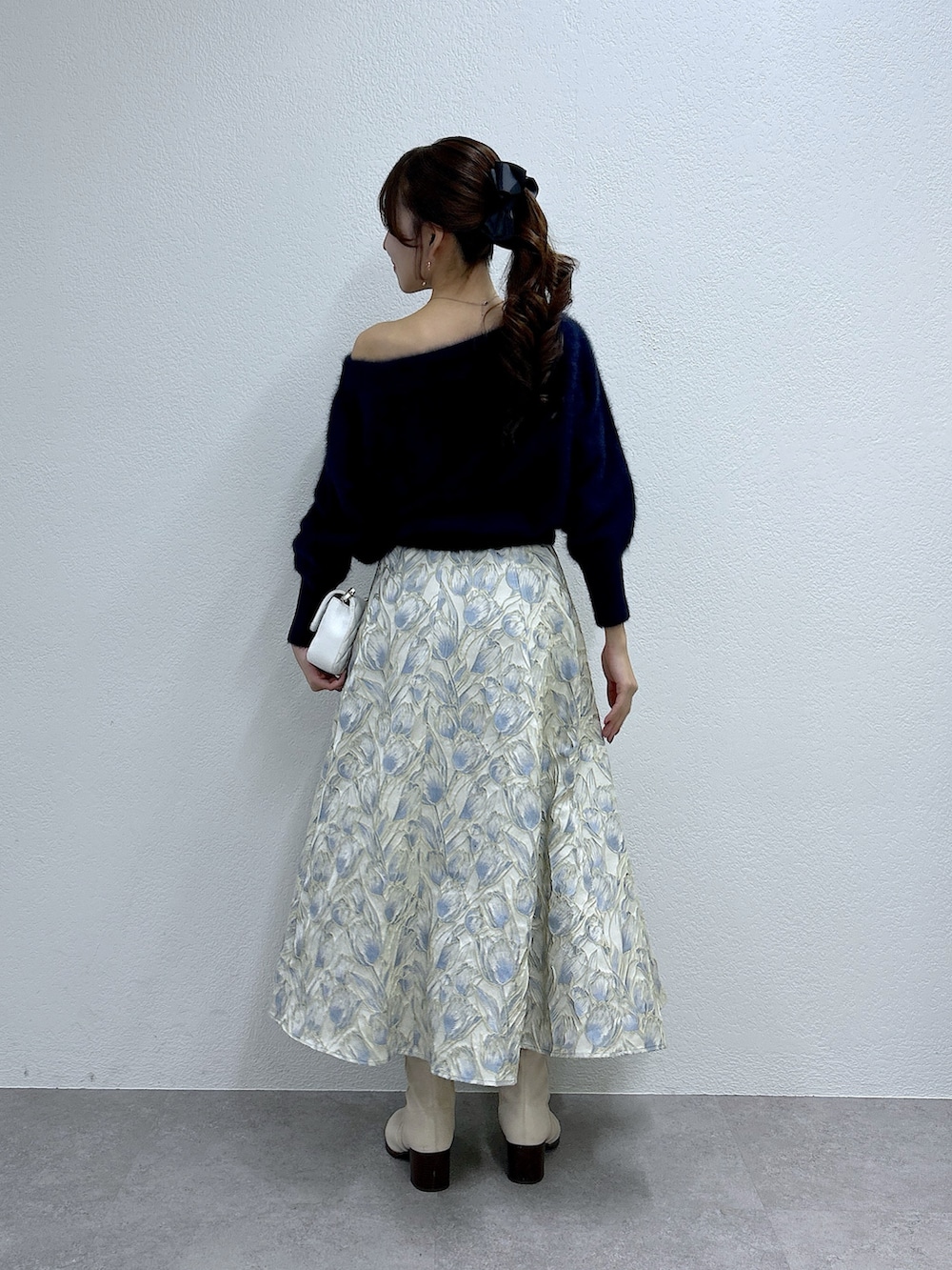 ブルー系のニット/セーター、ブルー系のスカートを着用したレディースの冬コーディネートの3枚目の写真