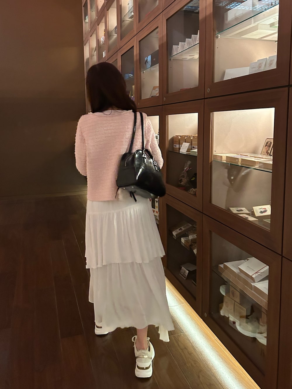 ピンク系のニット/セーター、ピンク系のニット/セーター、ホワイト系のスカートを着用したレディースの春コーディネートの5枚目の写真