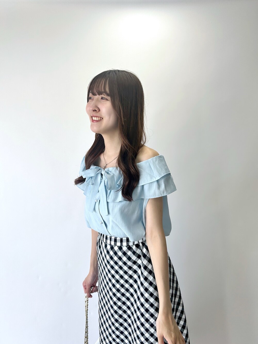 ブルー系のシャツ/ブラウス、ブラック系のスカートを着用したレディースの夏コーディネートの4枚目の写真