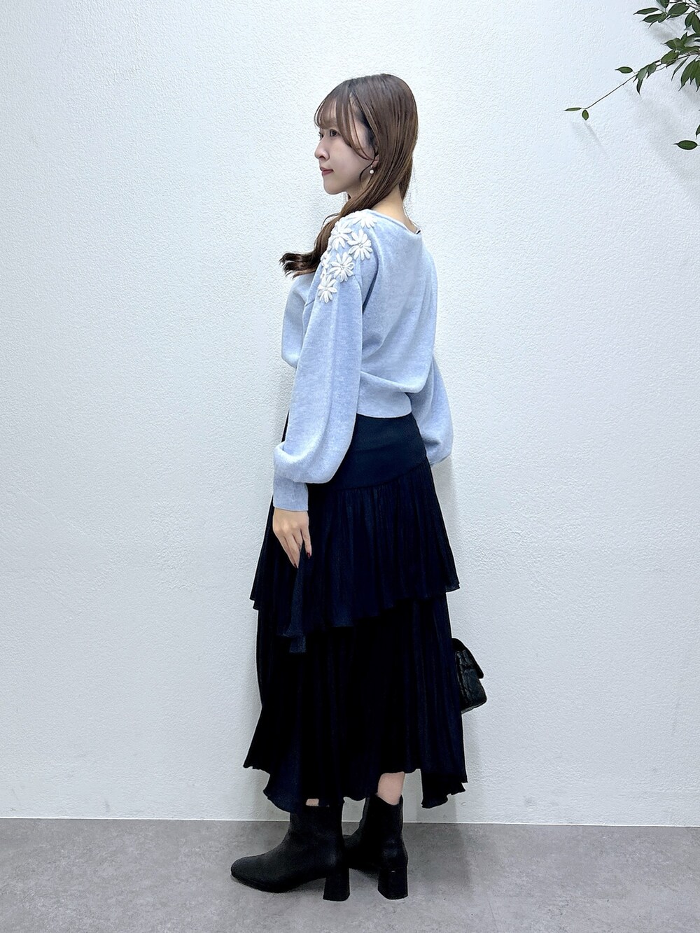ブルー系のニット/セーター、ブルー系のスカートを着用したレディースの秋コーディネートの2枚目の写真