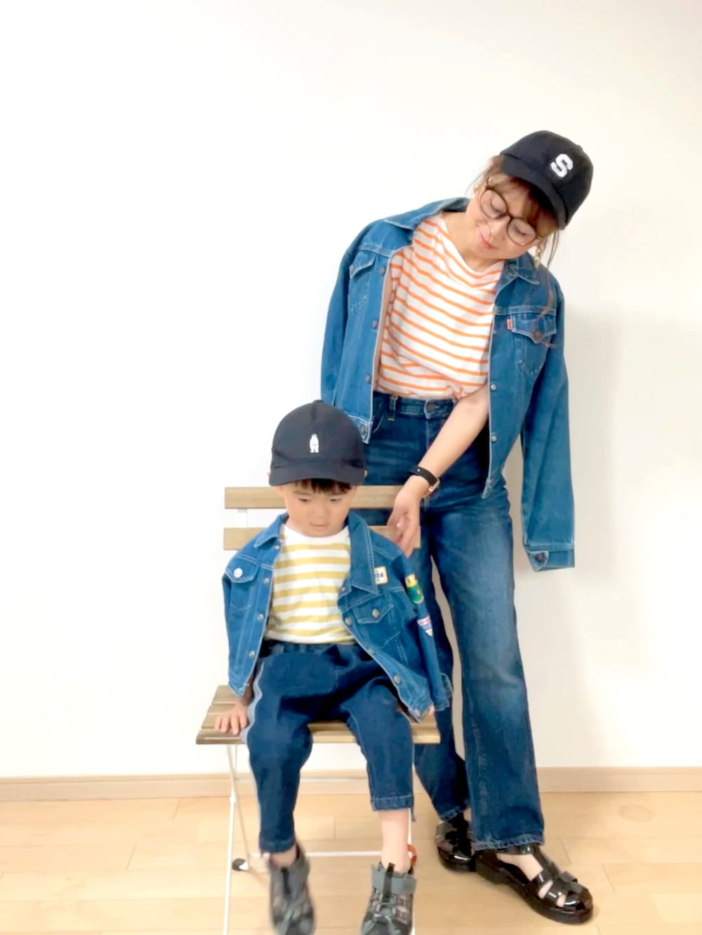 オレンジ系のTシャツ/カットソー、ブルー系のデニムパンツ、ブラック系のサンダルを着用したレディースの夏コーディネートの3枚目の写真