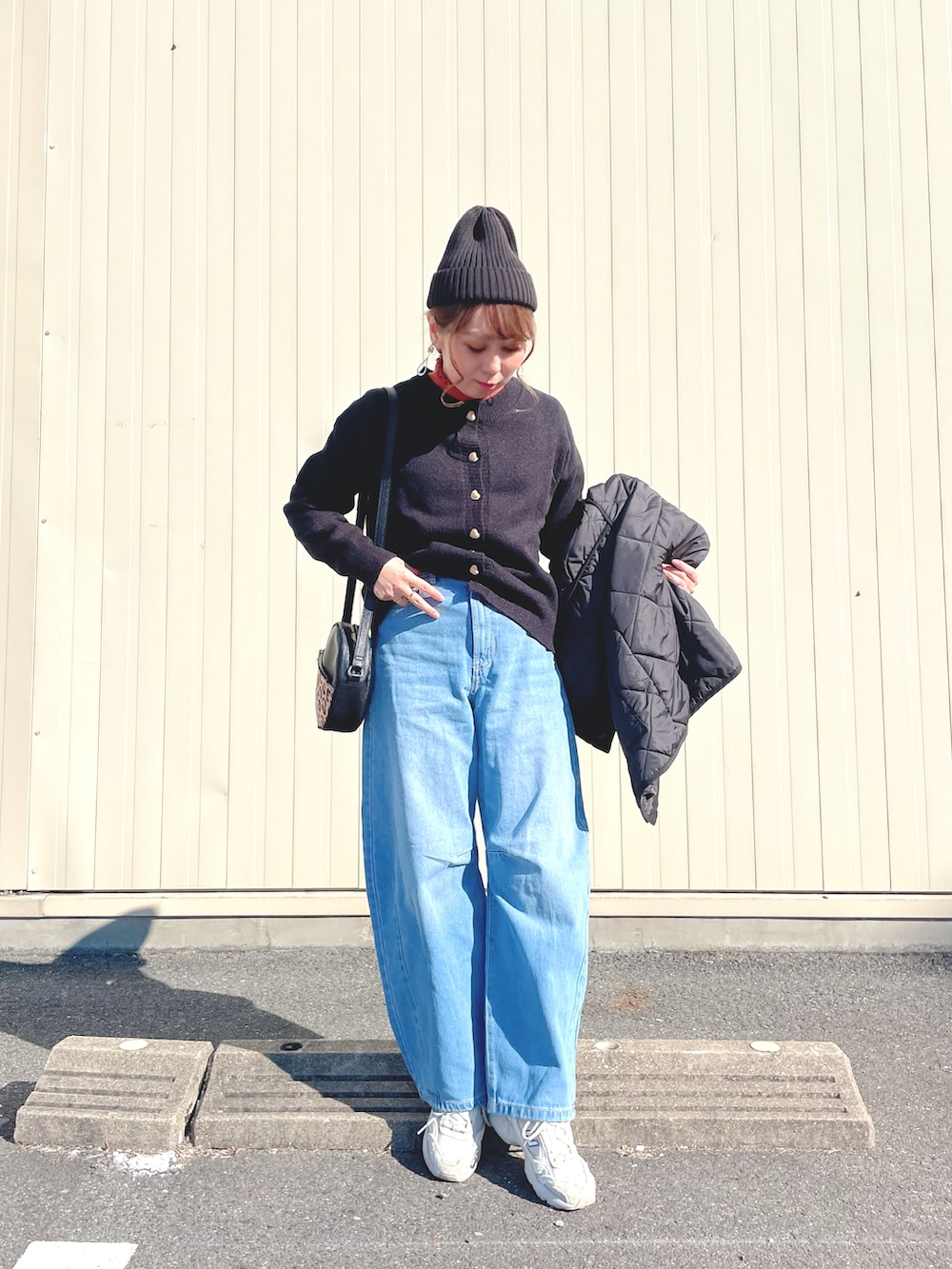 オレンジ系のトップス、ブラック系のカーディガン/ボレロ、ブラック系のジャケット/アウターを着用したレディースの冬コーディネートの3枚目の写真