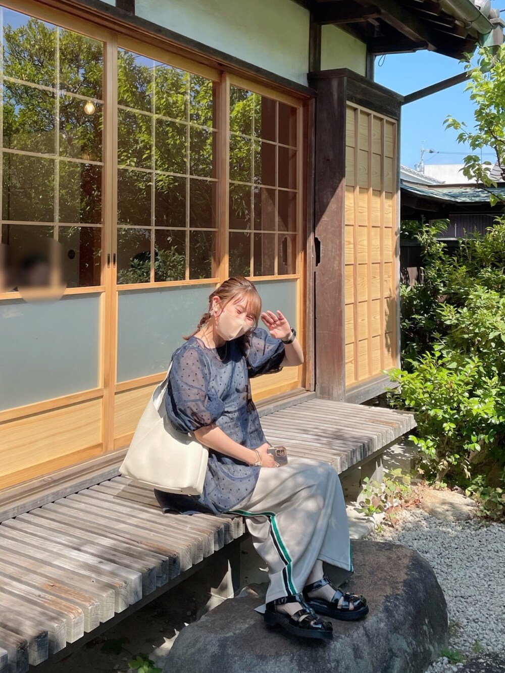 ブラック系のサンダル、ベージュ系のスカート、ホワイト系のバッグを着用したレディースの夏コーディネートの5枚目の写真