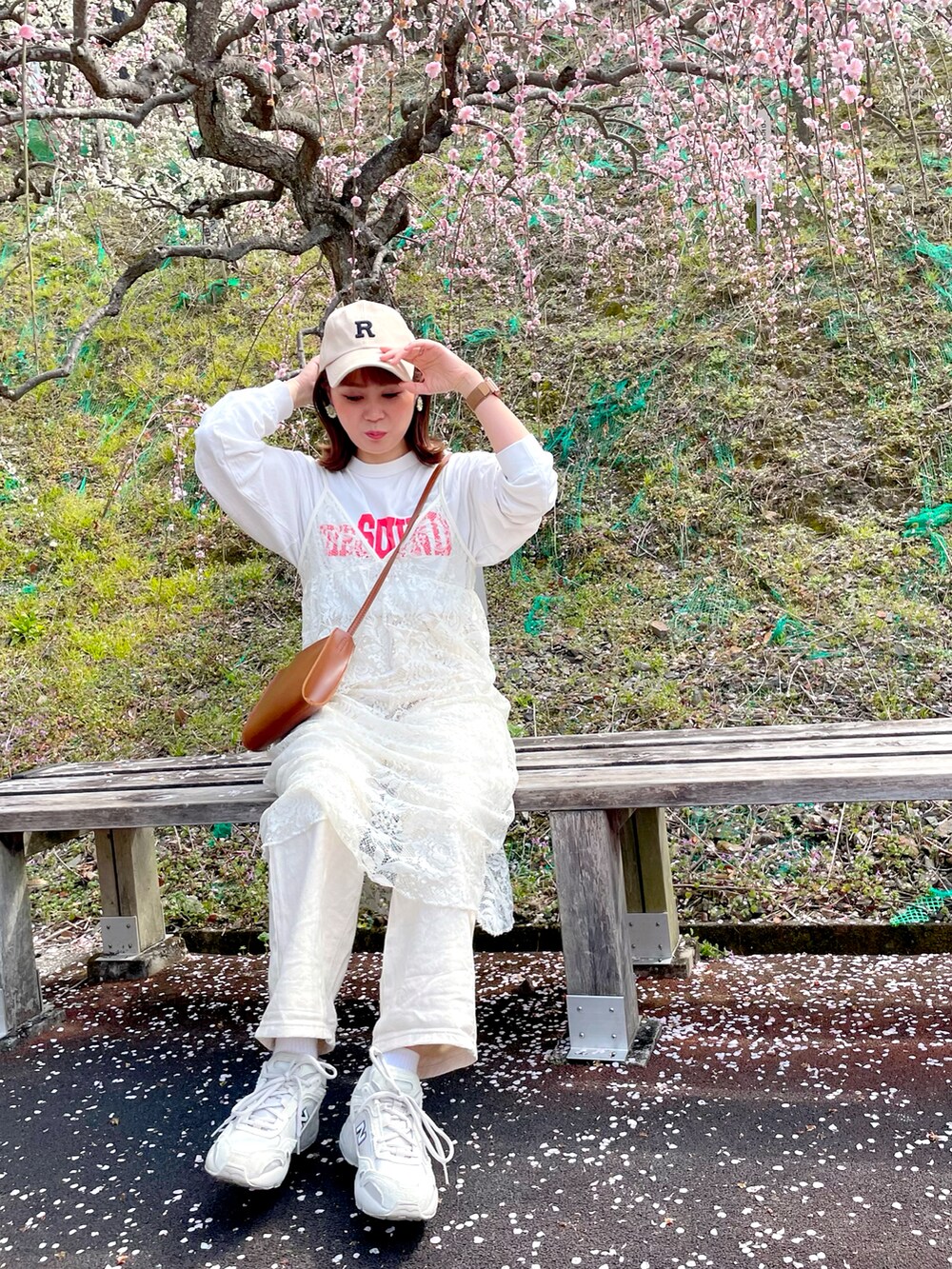 ホワイト系のTシャツ/カットソー、ホワイト系のワンピース、ベージュ系のデニムパンツを着用したレディースの春コーディネートの2枚目の写真