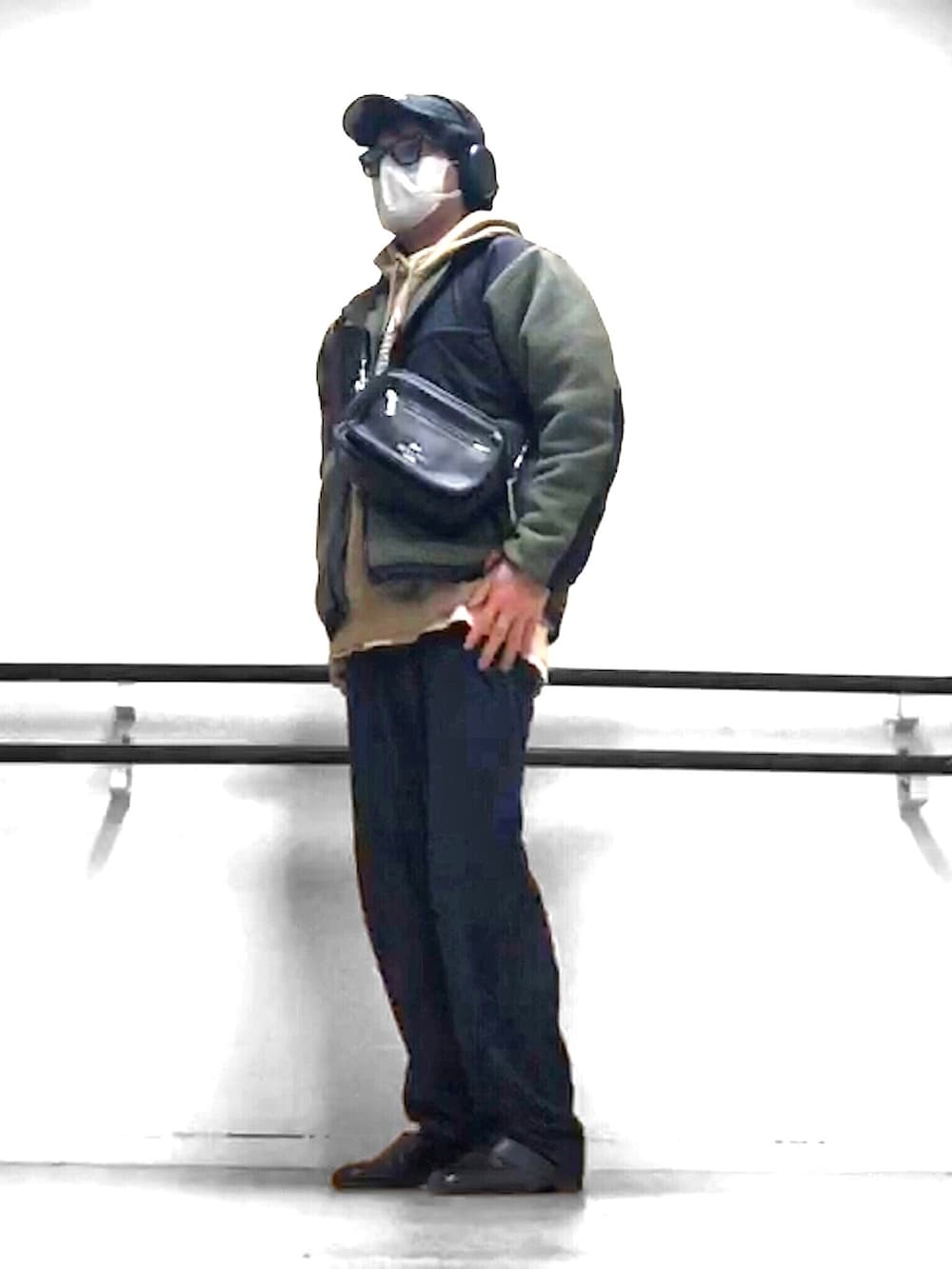 ベージュ系のパーカー、グリーン系のブルゾン、ブラック系のボディバッグ/ウエストポーチを着用したメンズの春コーディネートの3枚目の写真