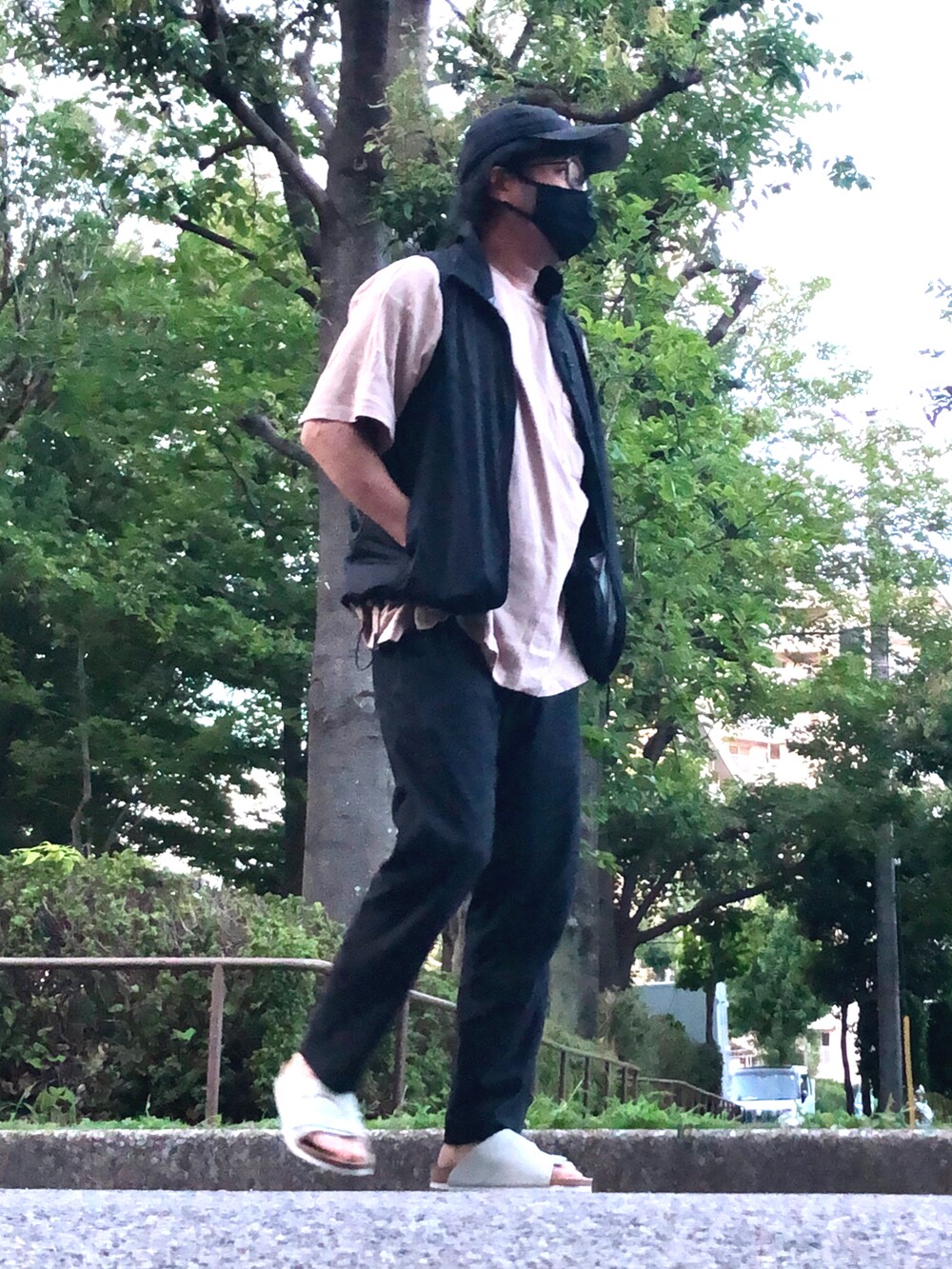 ブラック系のベスト、ベージュ系のTシャツ/カットソー、ブラック系のその他パンツを着用したメンズの夏コーディネートの2枚目の写真