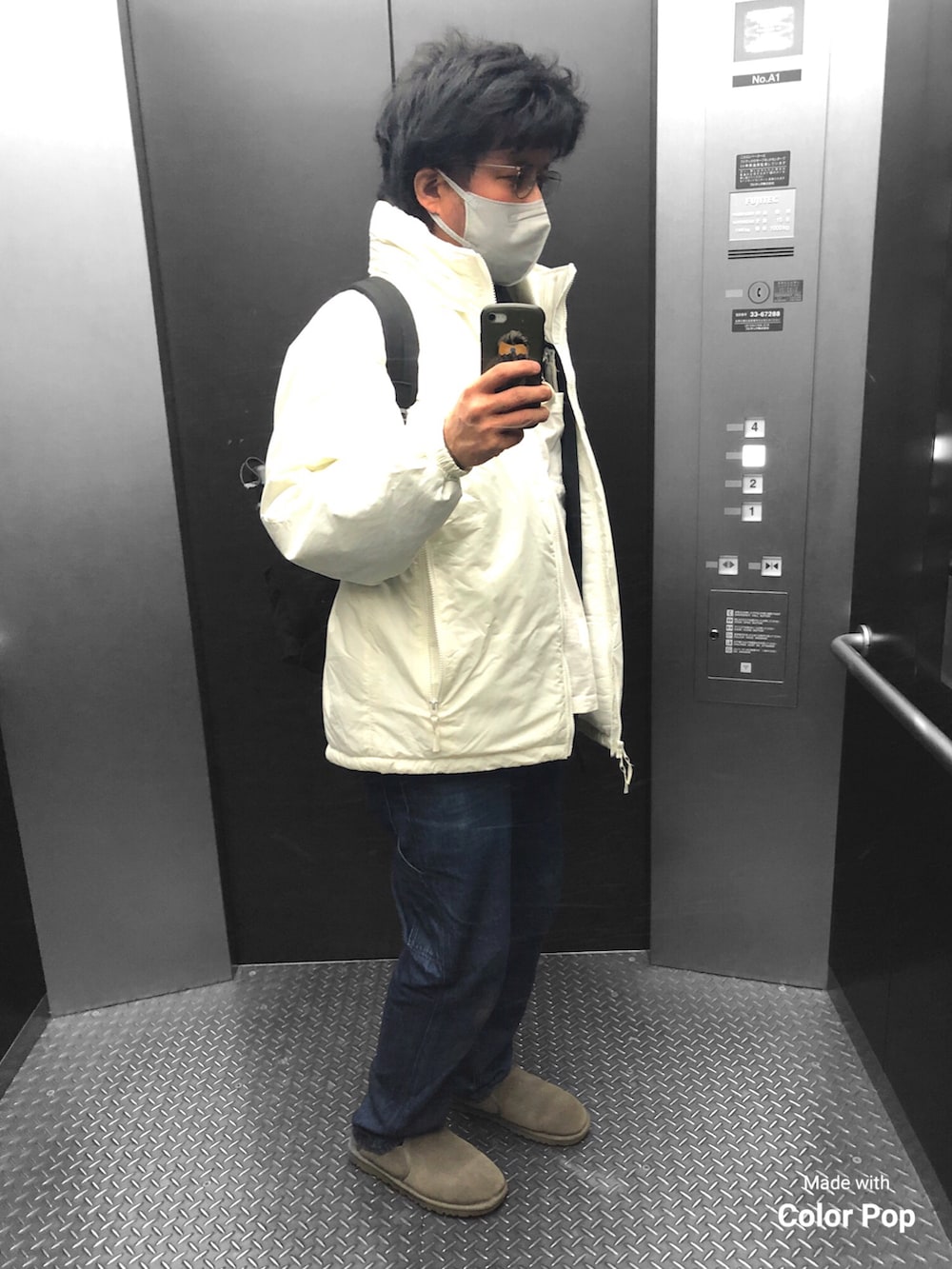 ホワイト系のブルゾン、ブラック系のジャージ、ブラック系のバックパック/リュックを着用したメンズの冬コーディネートの2枚目の写真