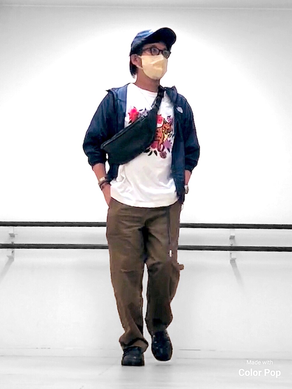 ブルー系のマウンテンパーカー、ホワイト系のTシャツ/カットソー、ブラック系のボディバッグ/ウエストポーチを着用したメンズの秋コーディネートの3枚目の写真