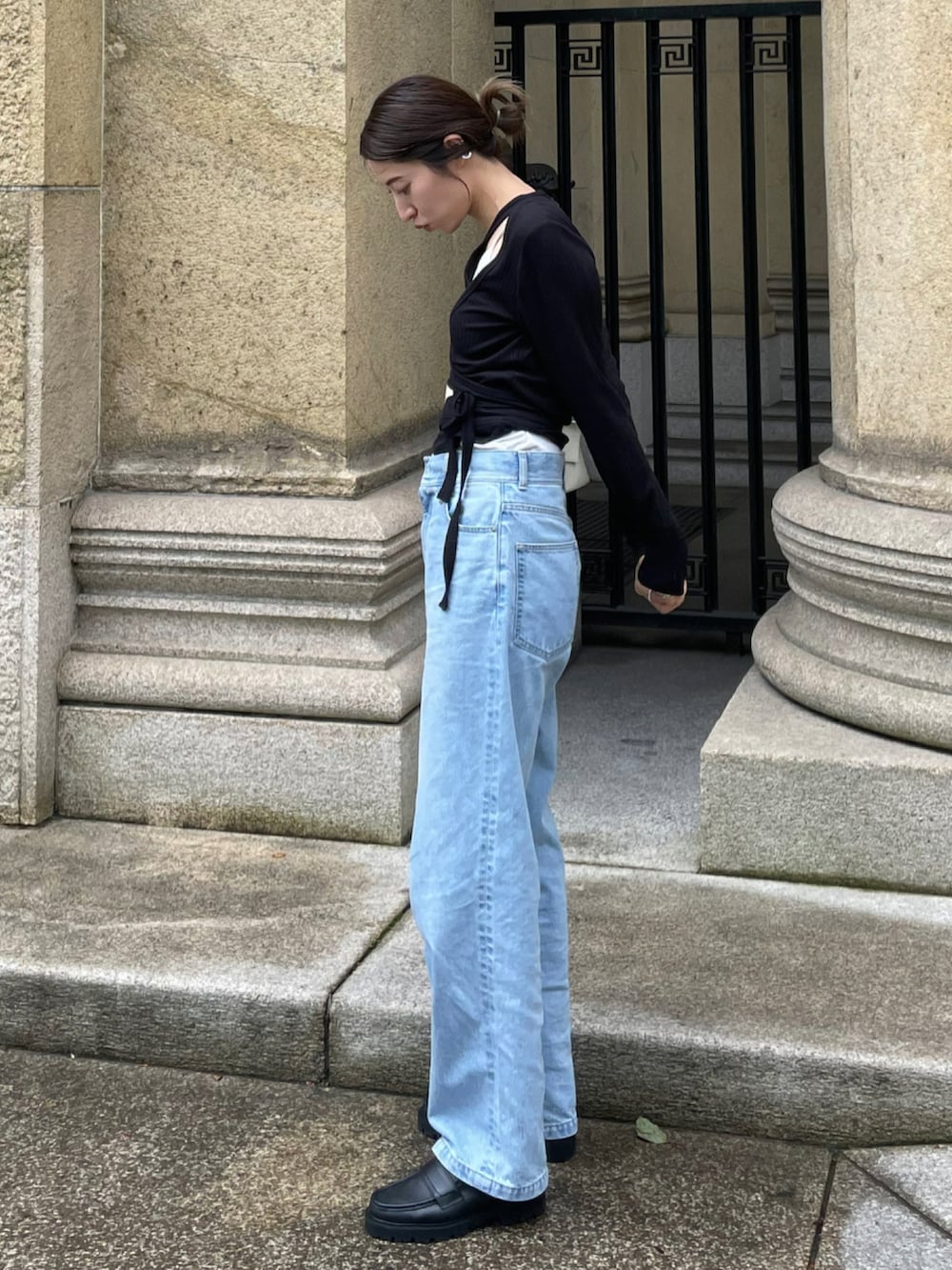 ブルー系のデニムパンツ、ブラック系のドレスシューズ、ブラック系のその他トップスを着用したレディースの夏コーディネートの3枚目の写真