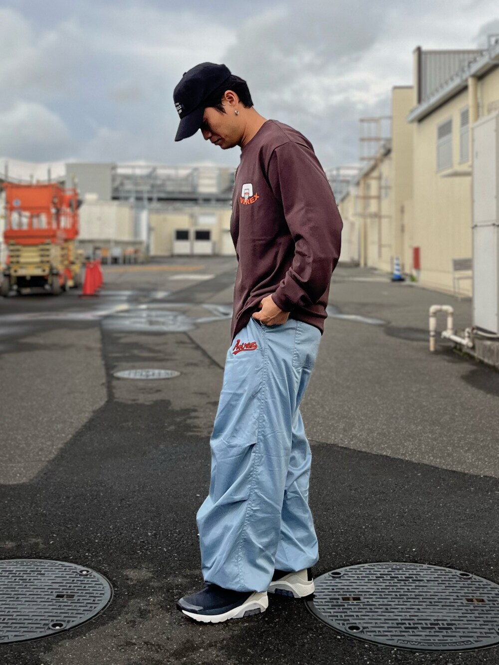 ブラウン系のTシャツ/カットソー、ブルー系のパンツ、ブラック系のキャップを着用したメンズの秋コーディネートの3枚目の写真