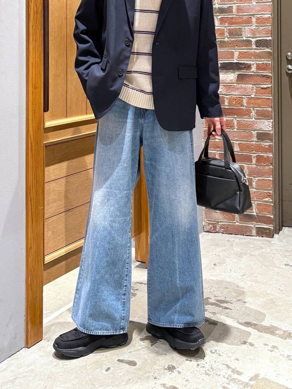 ブルー系のデニムパンツ、ブラック系のローファー、ブルー系のテーラードジャケットを着用したメンズの冬コーディネートの3枚目の写真