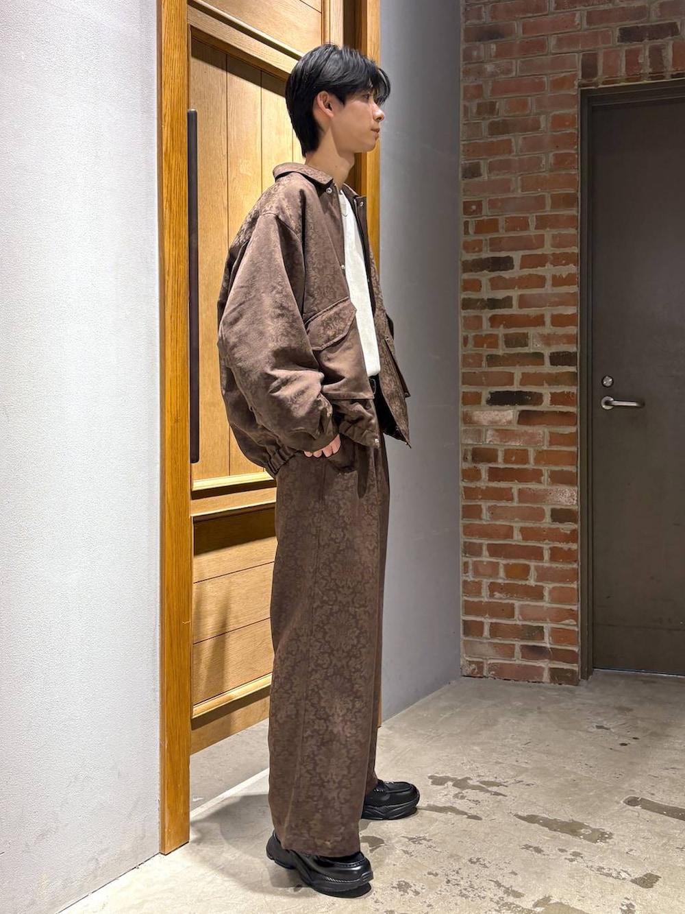 ホワイト系のスウェット、ブラック系のローファー、イエロー系のスラックスを着用したメンズの冬コーディネートの5枚目の写真