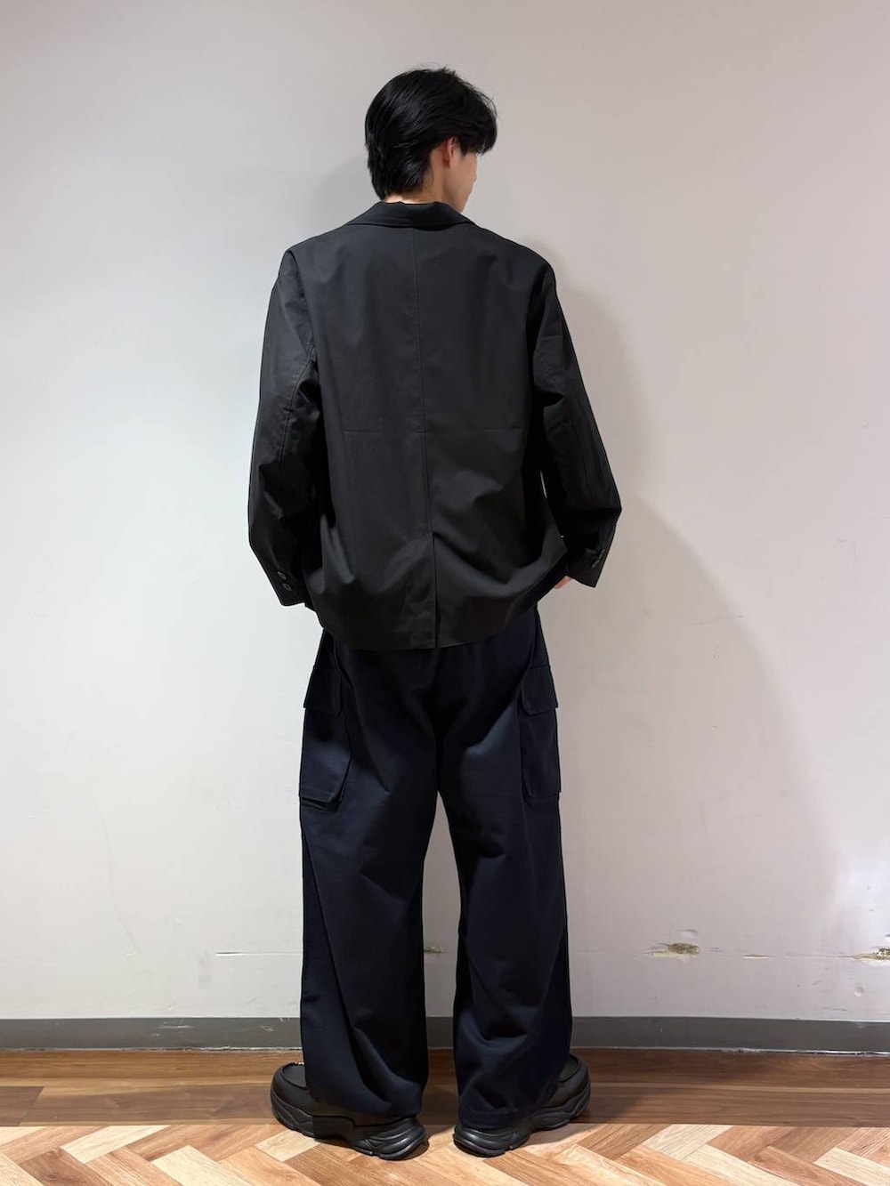 ブラック系のテーラードジャケット、ブラック系のローファー、ブルー系のTシャツ/カットソーを着用したメンズの春コーディネートの5枚目の写真