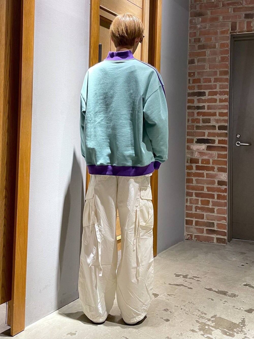 グリーン系のスウェット、ホワイト系のカーゴパンツを着用したメンズの春コーディネートの5枚目の写真