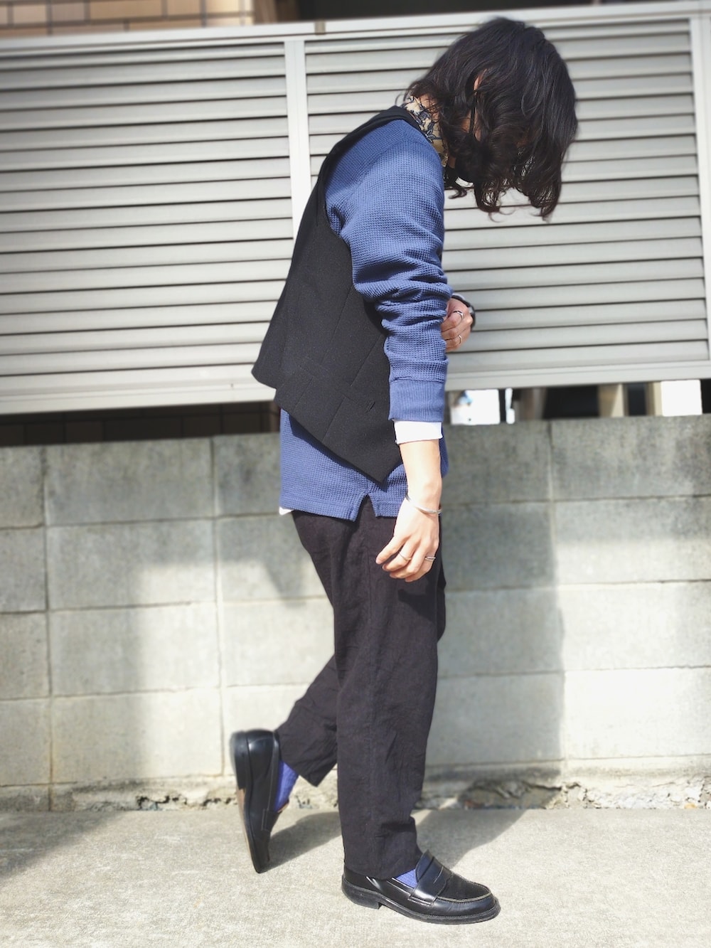 ブルー系のTシャツ/カットソー、ブラック系のベスト、ブラック系のその他パンツを着用したメンズの春コーディネートの2枚目の写真