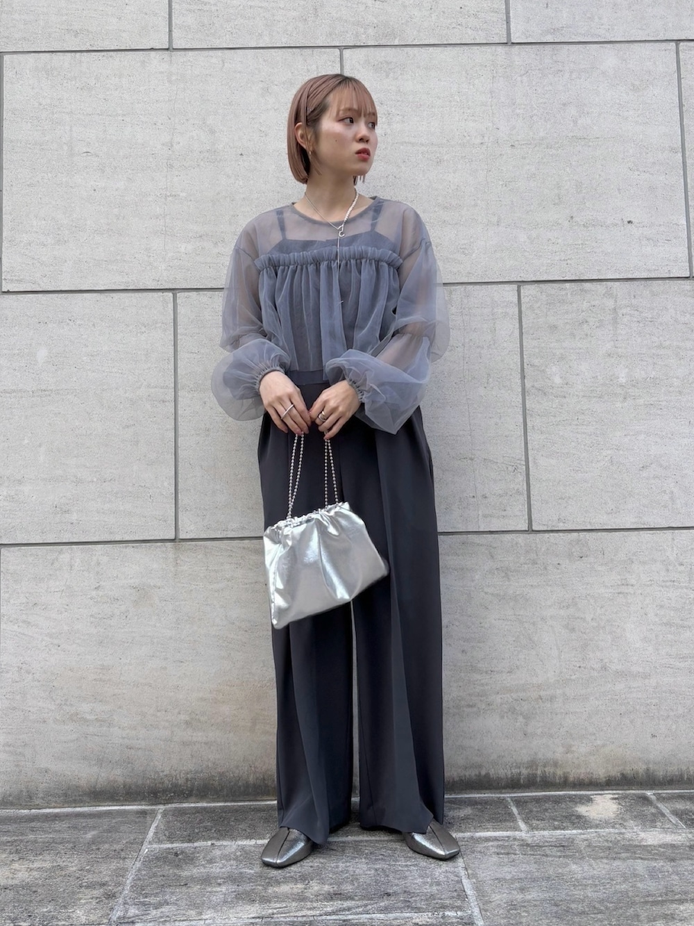 シルバー系のハンドバッグ、シルバー系のパンプス、グレー系のサロペット/オーバーオールを着用したレディースの冬コーディネートの5枚目の写真