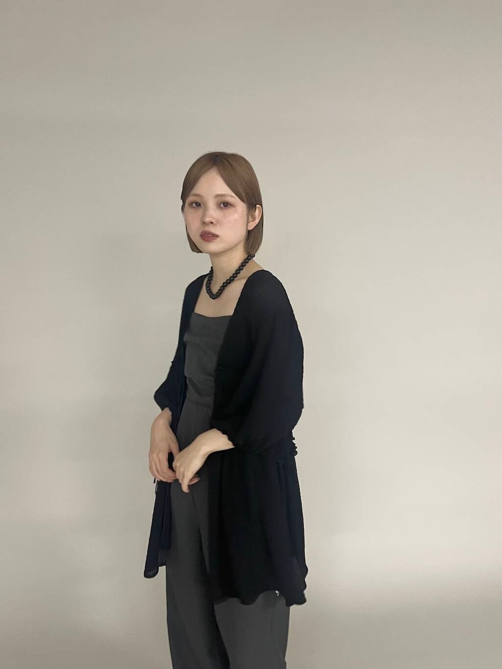 ブラック系のパンプス、グレー系のサロペット/オーバーオール、ブラック系のシャツ/ブラウスを着用したレディースの夏コーディネートの2枚目の写真
