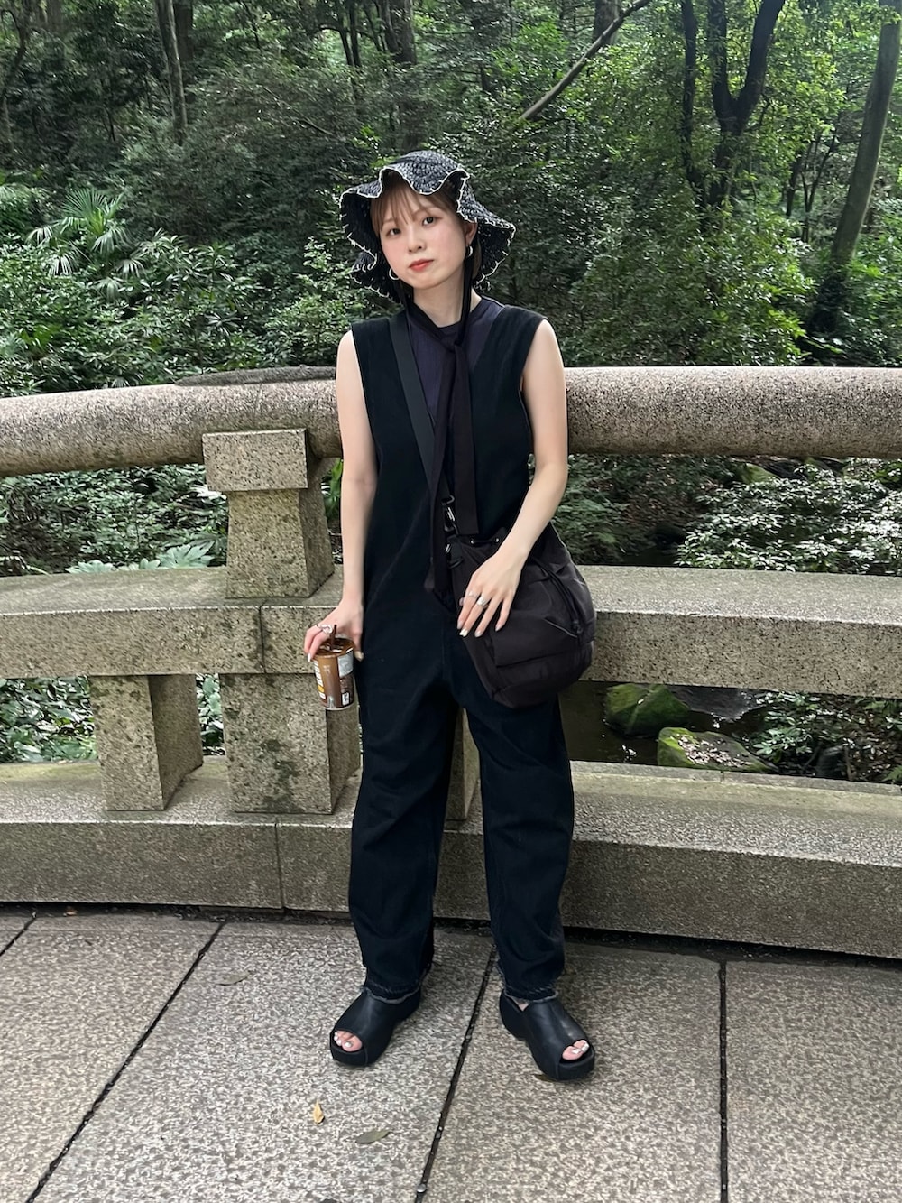 ブルー系のタンクトップ、ブラック系のサンダル、ブラック系のショルダーバッグを着用したレディースの夏コーディネートの4枚目の写真