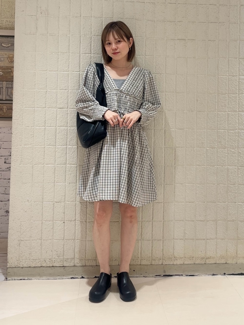 ベージュ系のワンピース、ブラック系のその他パンツ、ブラック系のショルダーバッグを着用したレディースの春コーディネートの2枚目の写真