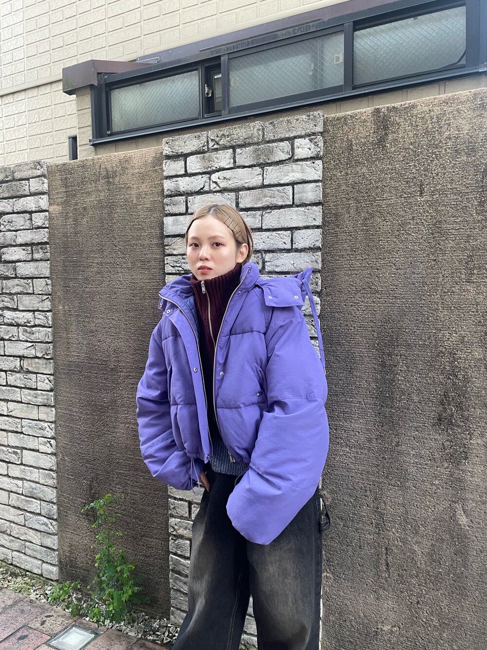 ブラック系のデニムパンツ、ブラック系のパンプス、ブルー系のニット/セーターを着用したレディースの秋コーディネートの4枚目の写真