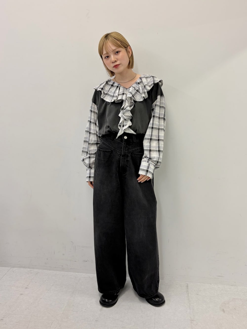 ブラック系のデニムパンツ、ブラック系のサンダル、グレー系のTシャツ/カットソーを着用したレディースの秋コーディネートの4枚目の写真