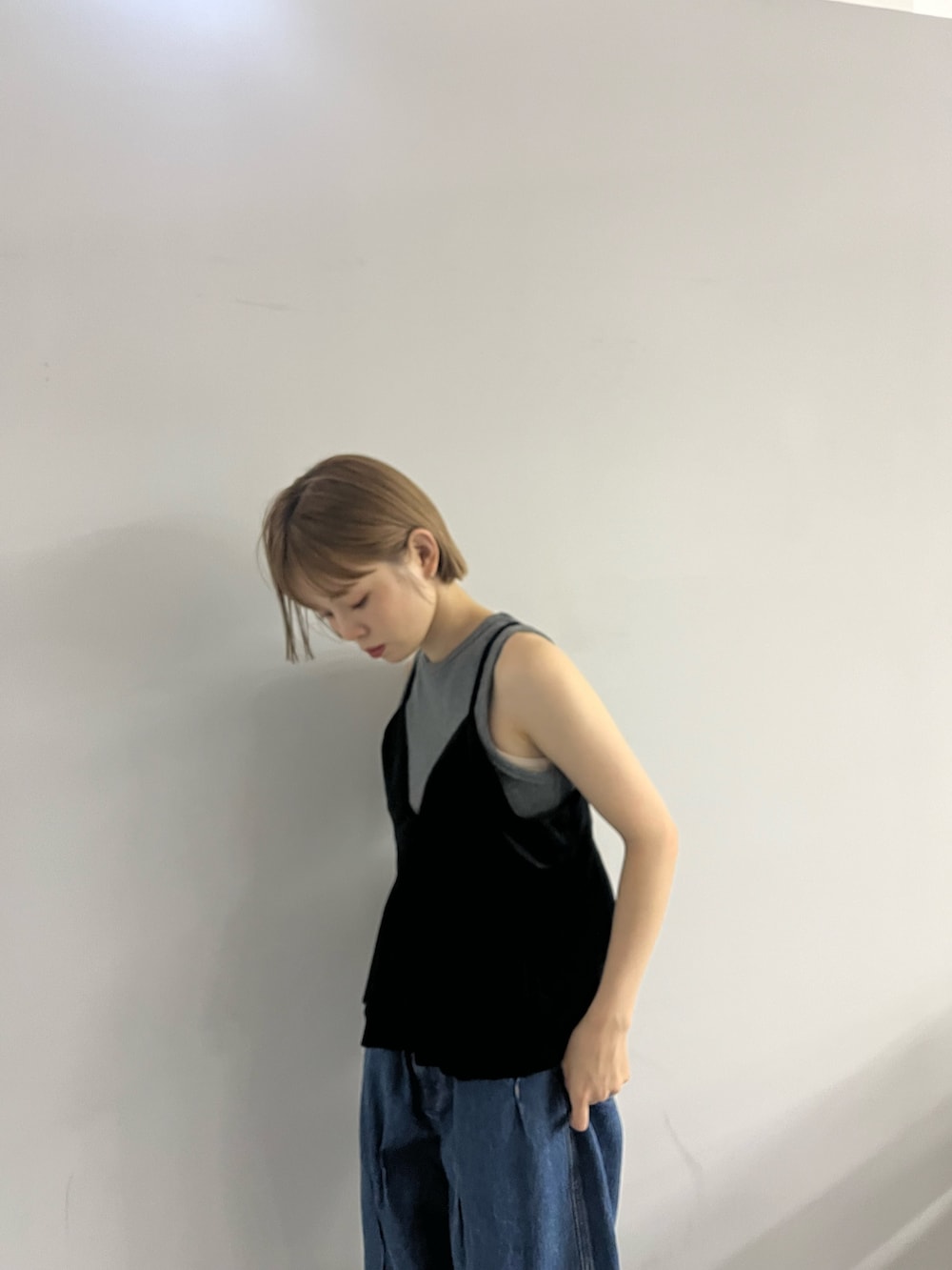 ブルー系のデニムパンツ、ブラック系のローファー、ブラック系のワンピースを着用したレディースの夏コーディネートの3枚目の写真