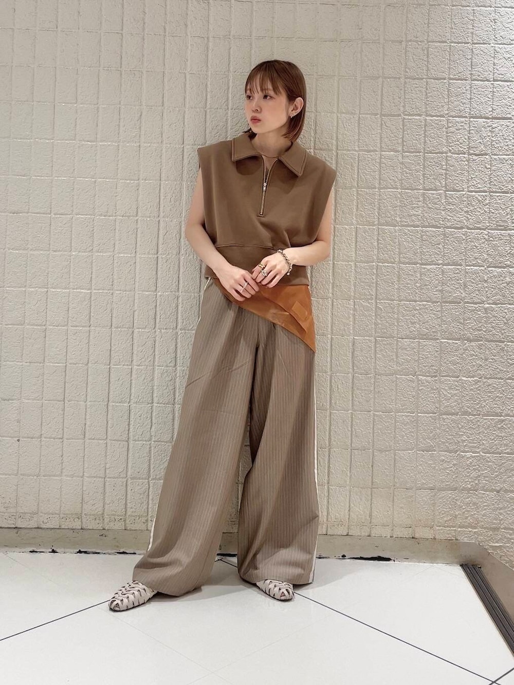 ブラウン系のスウェット、ベージュ系のその他パンツ、ブラウン系のバンダナ/スカーフを着用したレディースの夏コーディネートの3枚目の写真