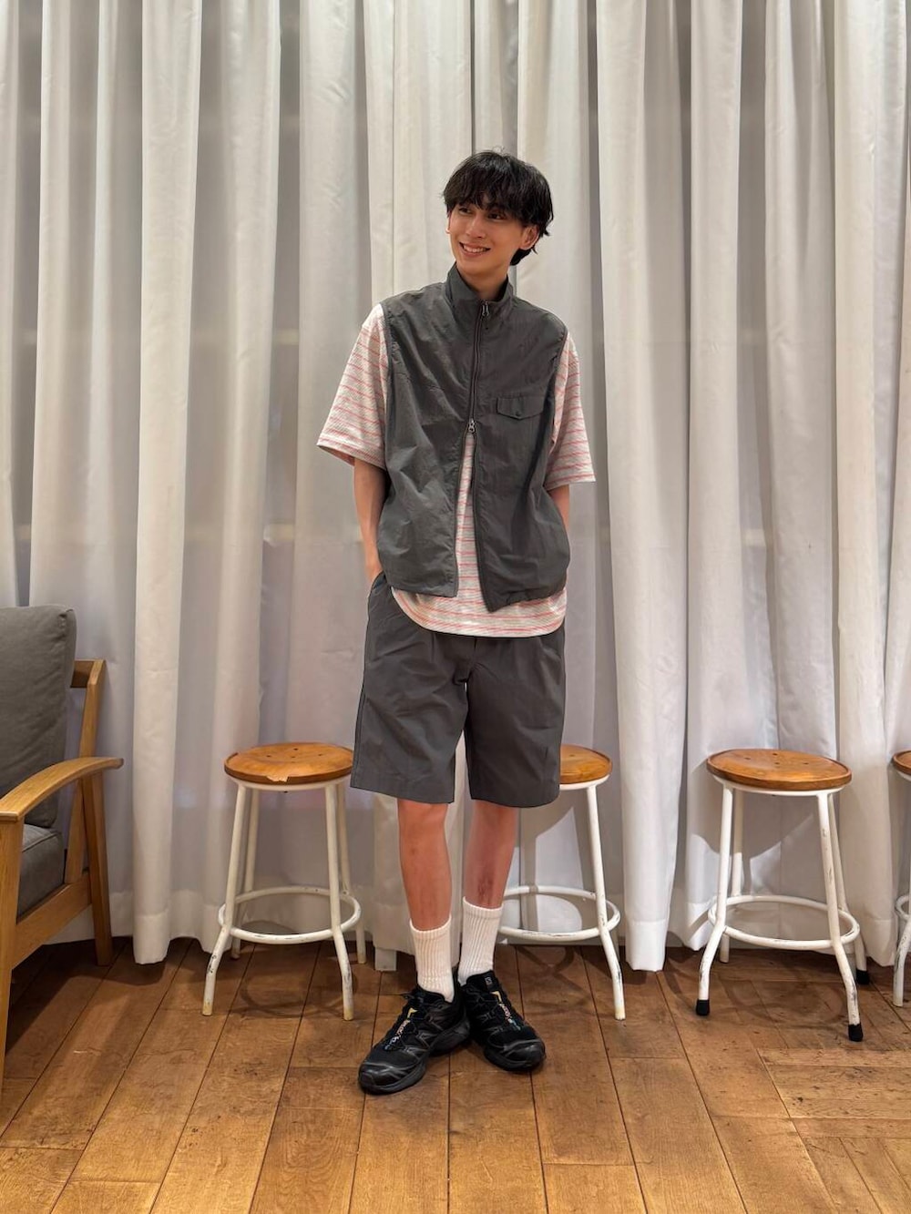 グレー系のベスト、グレー系のその他パンツ、ブラック系のスニーカーを着用したメンズの春コーディネートの3枚目の写真