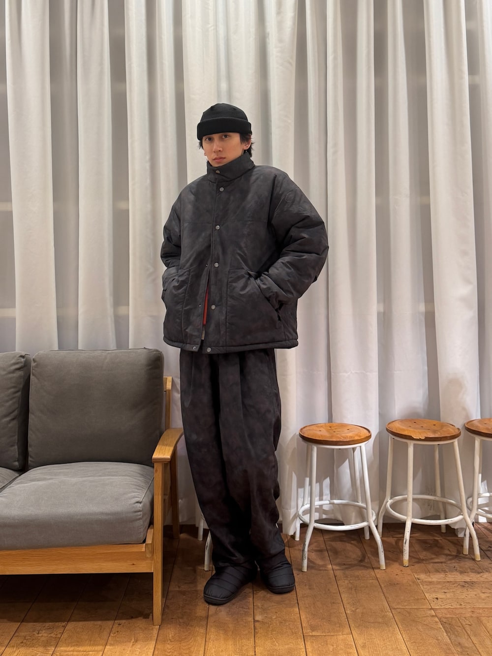 ブラック系のダウンジャケット/コート、オレンジ系のTシャツ/カットソー、ホワイト系のTシャツ/カットソーを着用したメンズの冬コーディネートの5枚目の写真