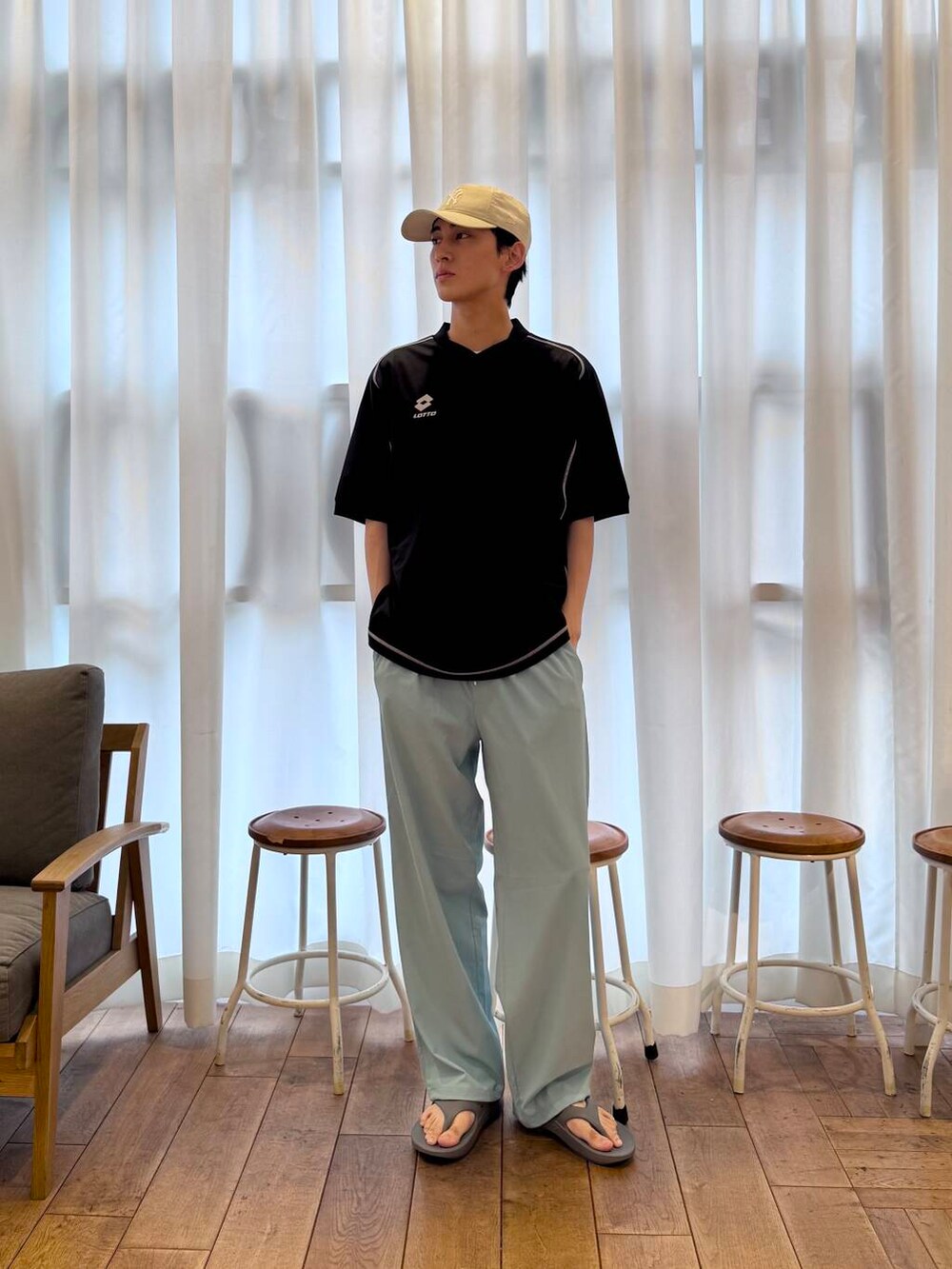 グレー系のサンダル、ブルー系のその他パンツ、ブラック系のTシャツ/カットソーを着用したメンズの春コーディネートの2枚目の写真