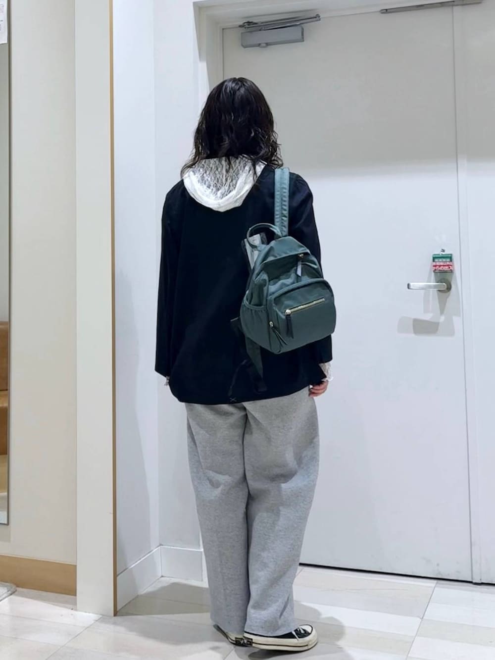グリーン系のバックパック/リュック、ホワイト系のTシャツ/カットソー、ホワイト系のタンクトップを着用したレディースの秋コーディネートの4枚目の写真