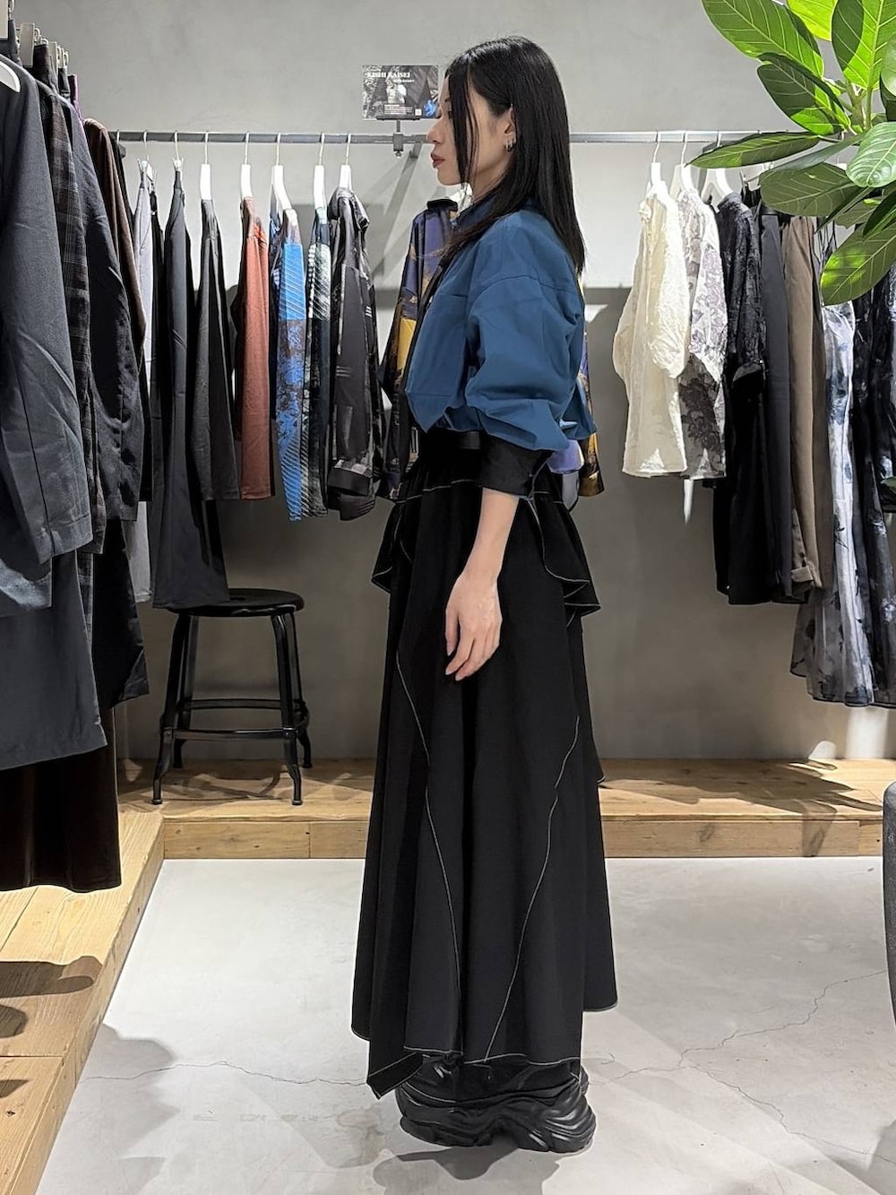 ブラック系のスカート、ブルー系のシャツ/ブラウス、ブラック系のスニーカーを着用したレディースの夏コーディネートの2枚目の写真