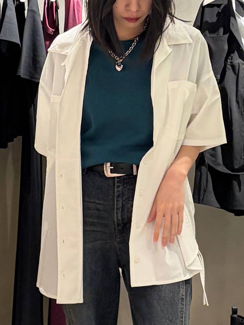 ブルー系のデニムパンツ、ブラック系のサンダル、ホワイト系のシャツ/ブラウスを着用したレディースの春コーディネートの4枚目の写真